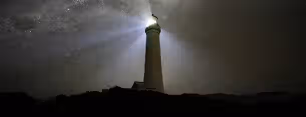 Guiding Through Darkness: A Leader's Emergence A lighthouse stands resilient under a starry sky, symbolizing a leader's journey to enlightenment and guiding others through darkness.