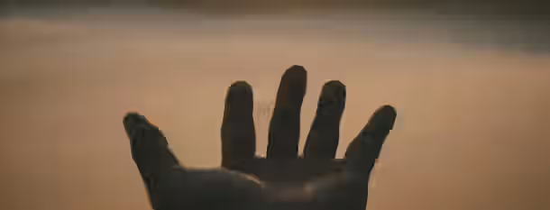 Reaching Towards New Horizons A hand reaches toward the horizon, symbolizing an emerging leader's journey toward self-improvement and new possibilities.