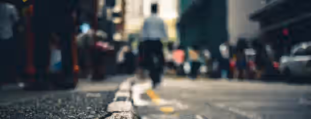Journey on the Path to Leadership A lone figure walks a blurred path amidst the bustling city, symbolizing the journey of an emerging leader finding clarity in chaos.