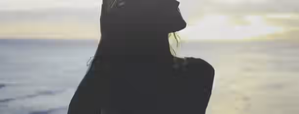 Dawn of Transformation: Cultivating Inner Strength Silhouette of a person gazing towards the horizon at sunrise, symbolizing an emerging leader’s journey towards self-improvement.