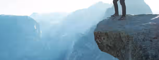 Standing Tall on the Edge of Potential Standing on the edge of a cliff, ready to embrace the journey ahead, symbolizing bravery and the pursuit of self-improvement.