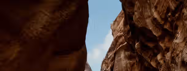 Ascending Through the Canyon of Growth Narrow canyon opening to the sky, symbolizing an emerging leader's journey through challenges towards new possibilities.
