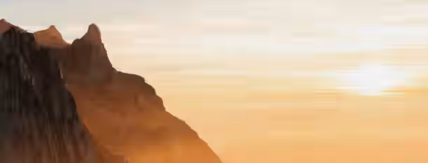 Climbing Towards Purposeful Leadership Climbing jagged peaks towards a golden sunrise, symbolizing the challenging yet rewarding path to self-improvement and leadership.