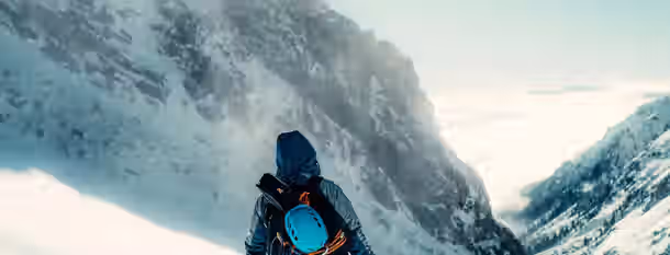 Scaling Heights: Path to Leadership Mastery Climber faces towering snowy peaks, symbolizing the emerging leader navigating challenges on the path to self-improvement.