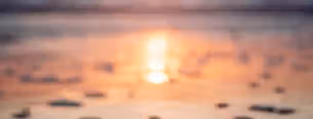 Dawn of Leadership: Rising Beyond the Horizon Golden dawn over shimmering waters symbolizes the dawn of self-discovery and personal growth on the path to becoming a leader.