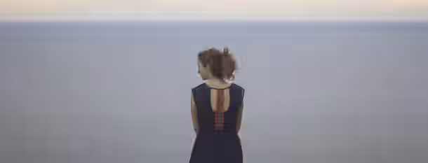 Reflective Beginnings: A Leader's Path to Growth Standing at the edge of an endless horizon, she contemplates the vast possibilities of her leadership journey.
