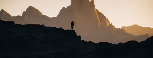 Climbing Heights: A Leader's Path to Growth A lone figure stands on a rugged peak, gazing at towering mountains ahead, embodying the path of an emerging leader's self-improvement journey.