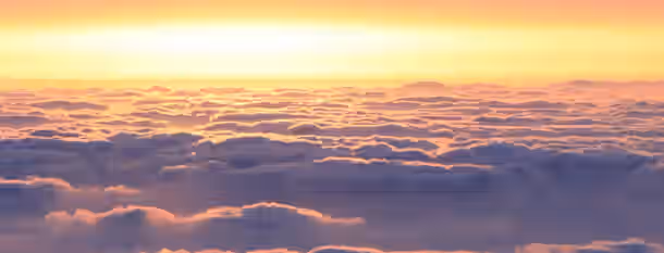 Rising Above the Clouds: A Leader's Dawn Sunrise above the clouds symbolizing a leader's ascent towards clarity and self-improvement, breaking through barriers to new horizons.