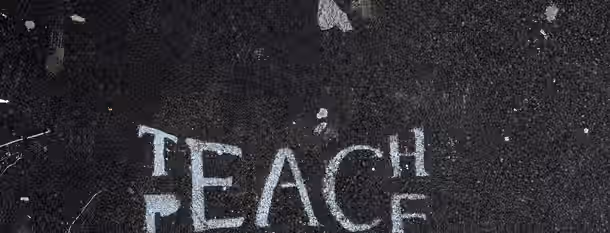 Paving the Path to Peaceful Leadership Chalked words "Teach Peace" on rough pavement, symbolizing the emerging leader’s path of spreading wisdom amid challenges.