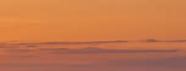 Sunset Horizons: Path to Leadership An inspiring horizon with layers of clouds glowing in dawn's warm light, symbolizing the emerging leader's journey to self-improvement.