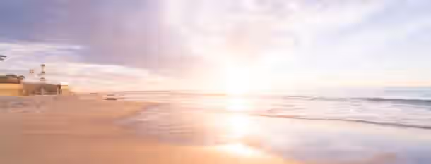 Sunrise of Leadership: Path to Self-Improvement Sunrise at a tranquil beach, symbolizing the start of a leader's journey to growth and self-improvement.