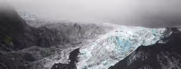 Ascending Glacial Peaks: A Leader's Journey Small figures ascend a vast, icy glacier under a misty sky, symbolizing an emerging leader's challenging journey to personal growth.